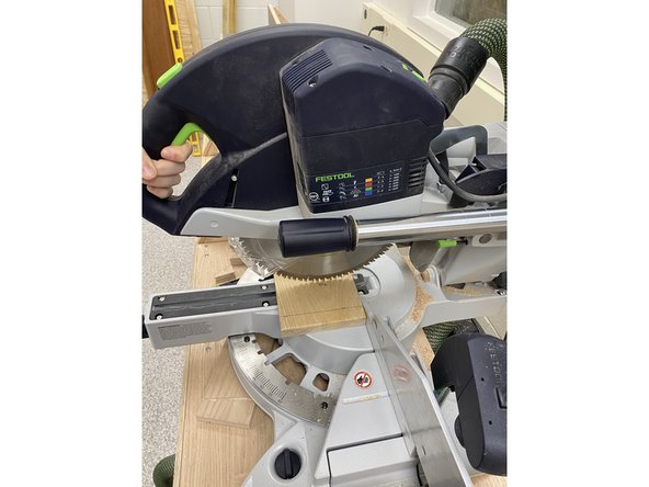 This unlocks the saw and lets it freely move down towards the workpiece.