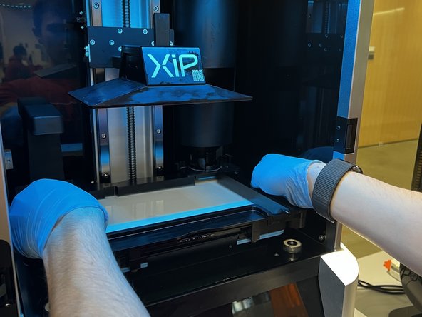 Grabbing both sides of the tank, gently lift it up and out of the machine.