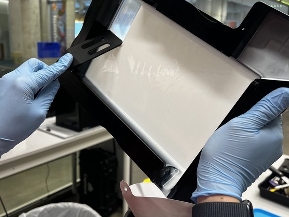 Once most of the resin is poured out, use a rubber spatula to scrape the rest down towards the spout.