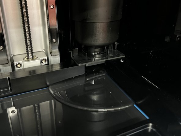 The resin should begin flowing out of the cartridge into the tank.