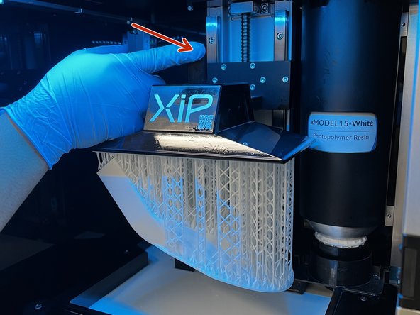 Push down on the latch holding the build plate in place.