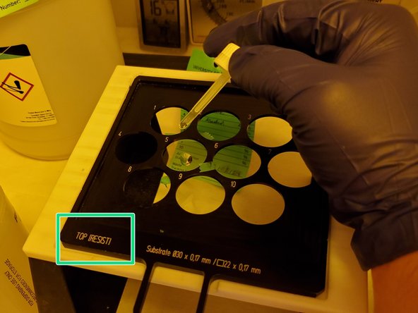 Apply a drop or two of the immersion oil to the center of the slide.