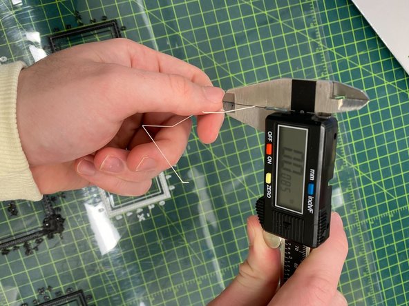 Use a razor blade or knife to carefully peel the top layer off the inner box of the calibration part. This top layer will be support material, while all the layers beneath it are model material