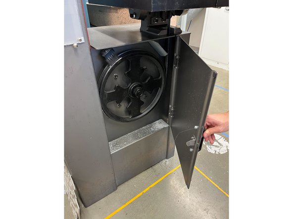 Open the door and using a brush, sweep the dust and shavings to the opening on the right. Be sure to dust off the wheel and door as well.