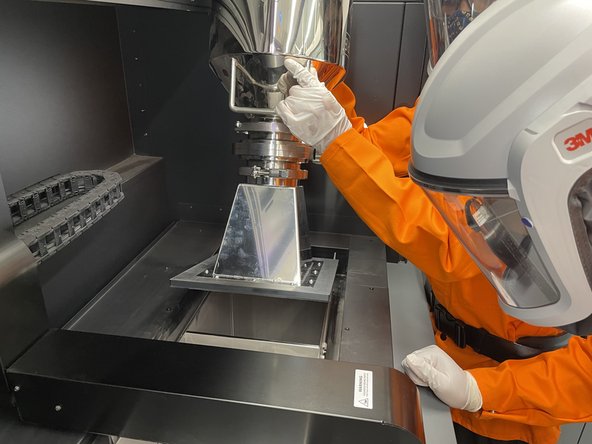 5-10 minutes after tapping funnel with rubber mallet, slowly lift an edge of the funnel up and have a second operator look inside to see if powder is being kicked up