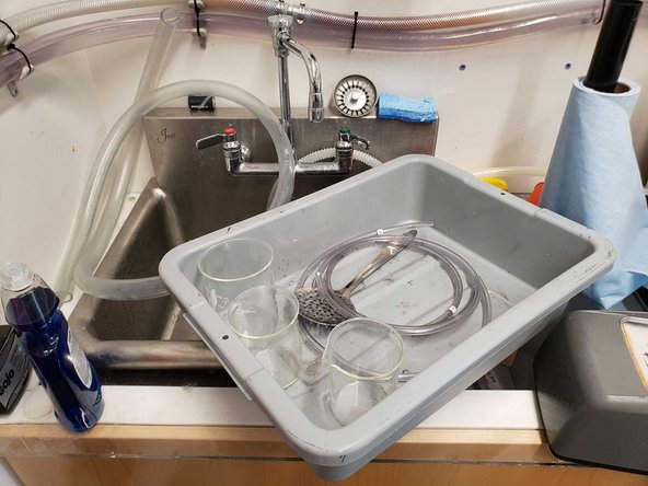 Rinse the plastic tubes, slotted spoon. and beakers with water