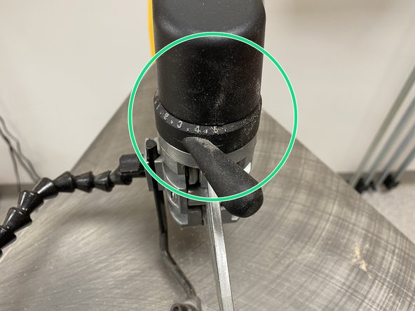 The guard should not be directly resting on the workpiece, but should still be relatively close.