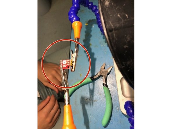 Once both parts are clamped move the helping hands close enough so that the short pins go all the way through the three holes on the LED