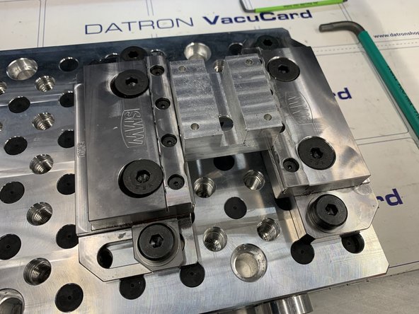 Slide the moving jaw into the part until clamping bolts appear eccentric on vise.