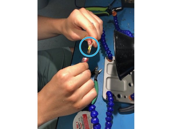 Clamp the longer pins of the corresponding LED so the short pins are pointing up