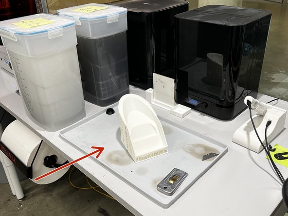 Take the part out of the Nexa3D Cure+Wash and place it on the silicone post-processing mat.