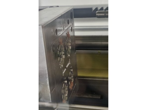 Issue: Part material remains adhered to the mold or becomes lodged between the ejector pins after ejection. Images 1 and 2 feature areas where stuck plastic is commonly found and should be inspected for adhered material.