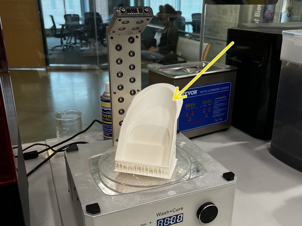 Place the model (with supports intact) on the rotating base.