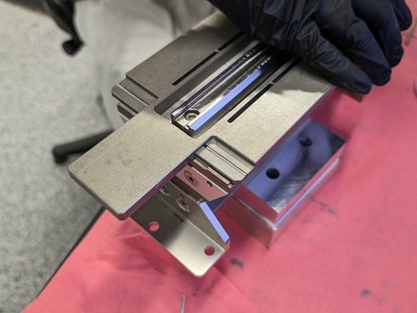 Next we take remove the screws holding in the sliding doser block and the mounting flanges. Clean these areas with isopropyl and a cloth.