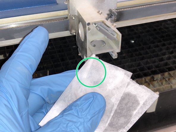 Wet a piece of lens paper with some Acetone