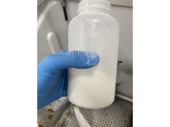 Place the bottle and funnel in the powder coating tub and turn on the vacuum