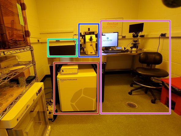 The electronics rack contains the Photonic Professional GT controller, various power supplies, the computer desktop, and the laser control unit.