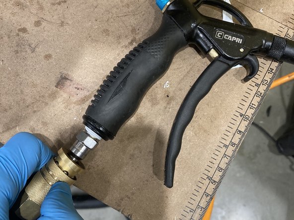 With the pressure on and the blower handle squeezed, pull down on the black knob and rotate it counter-clockwise until the pressure is at the desired level, then push the knob back up