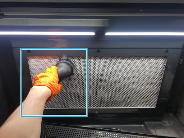 Remove the tool rack by lifting it up off of the screws it rests on. Place it on the work area, in front of the filter