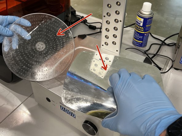 If the reflective film and rotating base are still in the Nexa3D Wash+Cure, remove them.