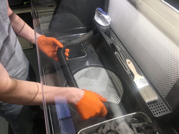Use the vacuum to clean up any remaining powder left in the work area