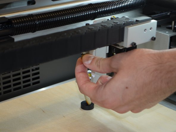 Place the focusing puck between the material and the head assembly.