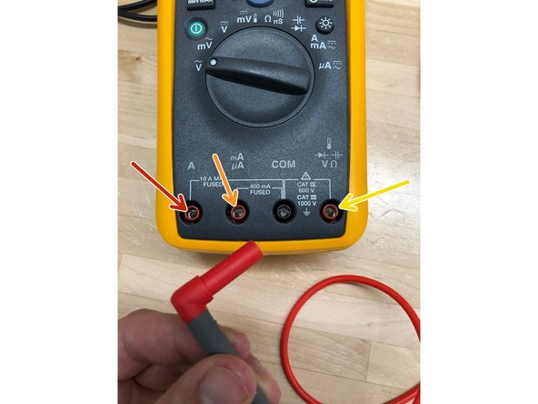 The red probe can be plugged into three different ports: