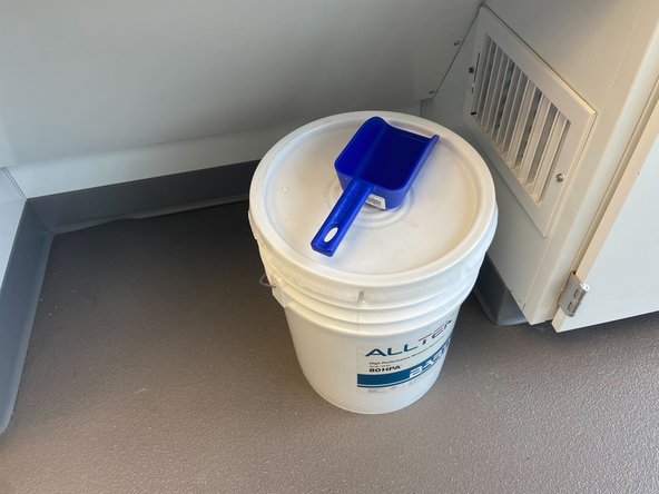 Next, you will need to fill the garnet hopper. This is accessed by lifting the eyewash up and leaning it into the sink, then pulling on the bottom of the left side of the machine