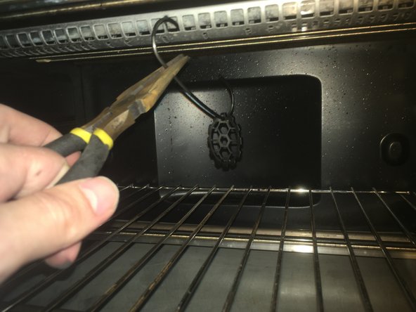 Carefully hang the part hook from the roof off the oven