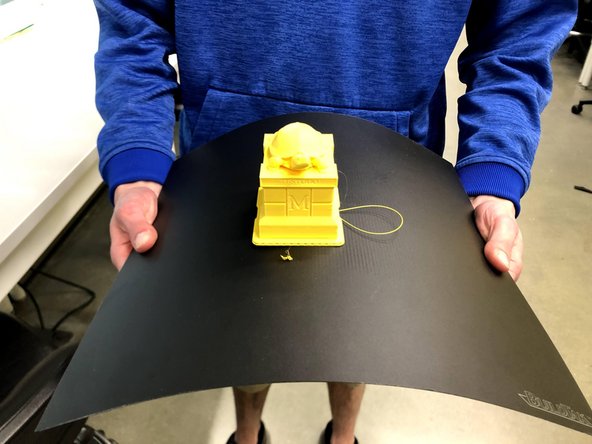 Flex the build plate in multiple directions to release the part