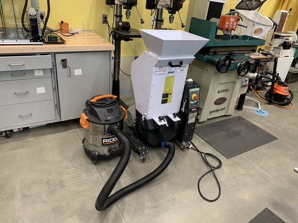 Turn on the shop vac and press the green button on the granulator.