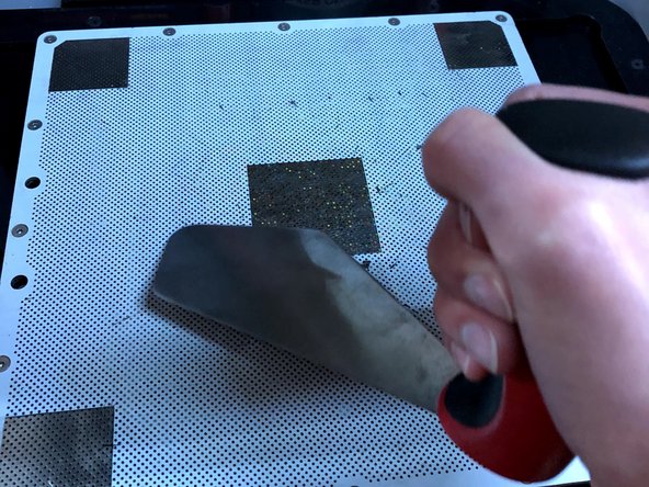 Use the spatula to lightly remove any filament stuck to the build plate