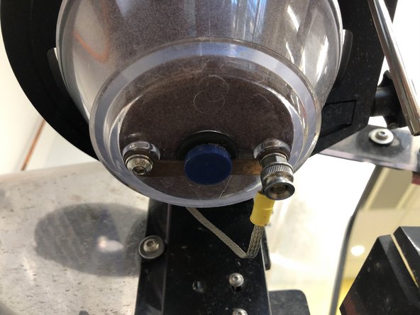 The granite block will simply slide out of the bottom of the hopper.