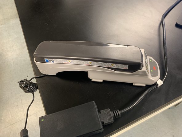 Match up battery and click into charger until all sides are flat and green light is on