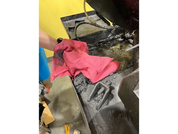 Use a paper towel to collect the chips and throw them in the trash can (NOT the rectangular bin with metal scraps)