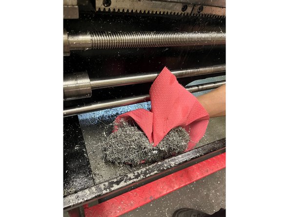 Use paper towels to pick up and dispose of the lathe chips