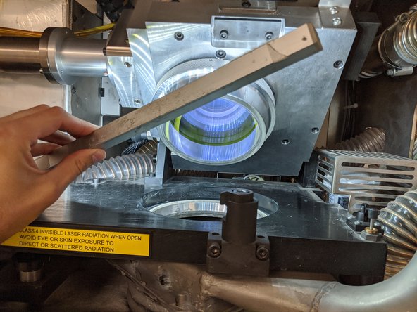 Use the bar light to help inspect the surface of the lens.