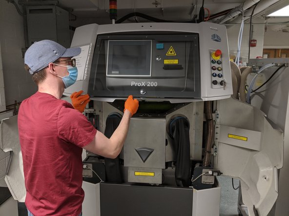 Carefully lower the hood, support the weight all the way down