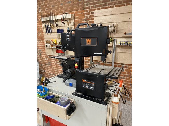 Both little band saws are located on the cart over by the saws and measurement tools wall