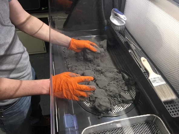 Move the powder cake (or top section if working with a taller cake) to the grate in the center of the work area