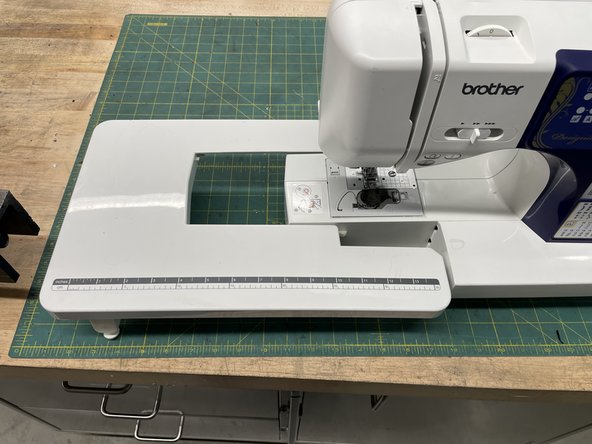 Insert the table into the sewing machine. Make sure all the tabs line up. You should hear a click when it is in.