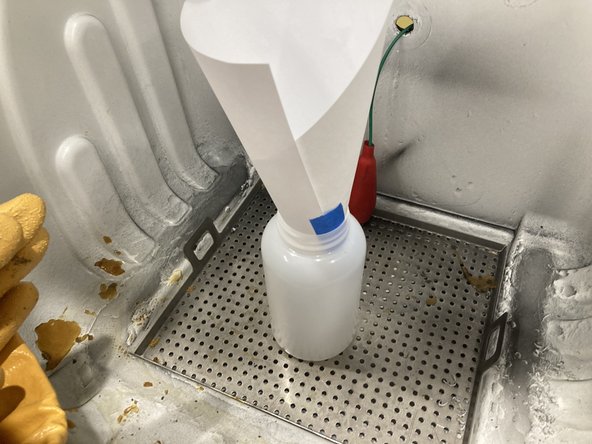 Use a funnel or make one out of a rolled up sheet of paper