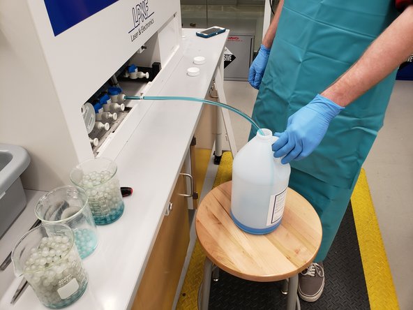 Place the other end of the plastic tube into a plastic jug (you may need to place it on a stool)