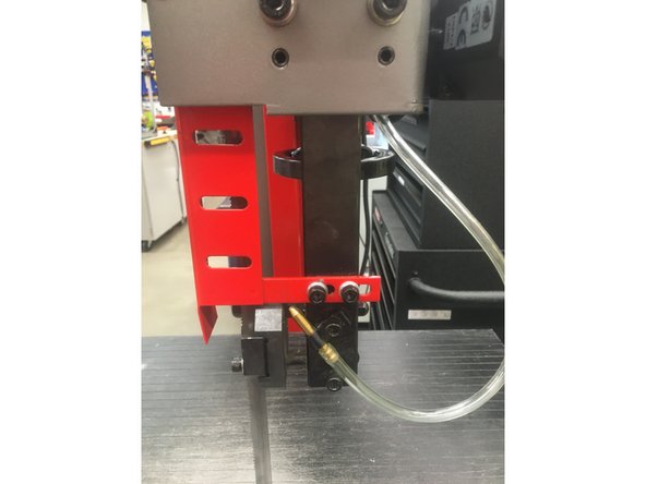 Ensure that the right red guard is secured back to the machine and that the blade is behind it.The guard should be tightened so that the guard is as close to the upper drive wheel as the bolt slots will allow.