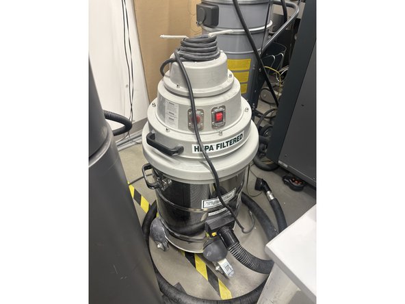 Look at HP TigerVac Vacuum. Observe that there are two separate hoses near the vacuum. One of the hoses leads straight to the brush attachment. The other leads to the SLS sandblaster.