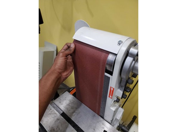 Once belt direction has been determined, pull the belt tensioning handle toward you with one hand.