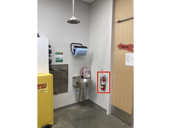 There is a fire extinguisher right inside the main entrance of the lab to the right.