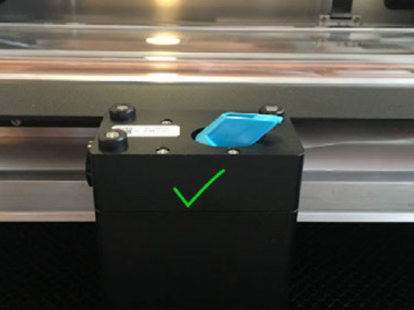 Hold the mirror by the handle and gently slide it into the notch with the mirror at a 45 degree angle to the top of the printer head