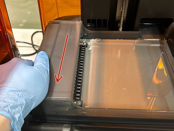 Grip both sides of the resin tank and pull backwards