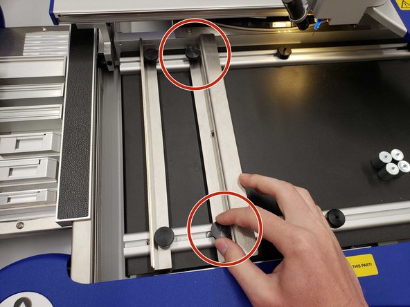 Release the right lath by unscrewing the knobs.